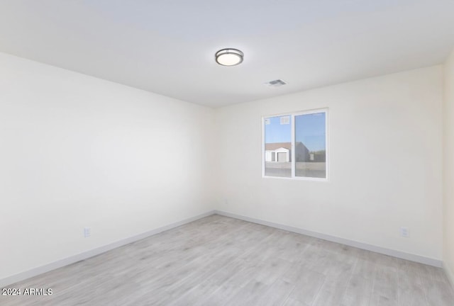 unfurnished room with light hardwood / wood-style flooring