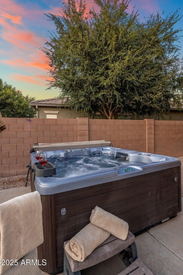 7616 S Sorrell Ln, Gilbert, AZ 85298 - patio terrace at dusk featuring a hot tub