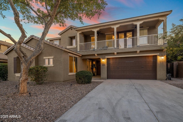 7616 S Sorrell Ln, Gilbert, AZ 85298 - front of property featuring a balcony, ceiling fan, stucco siding, concrete driveway, and an attached garage