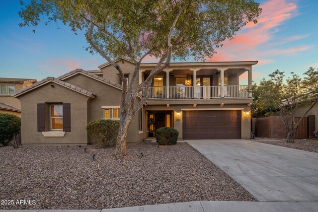7616 S Sorrell Ln, Gilbert, AZ 85298 - view of front facade featuring a balcony, concrete driveway, a garage, and stucco siding