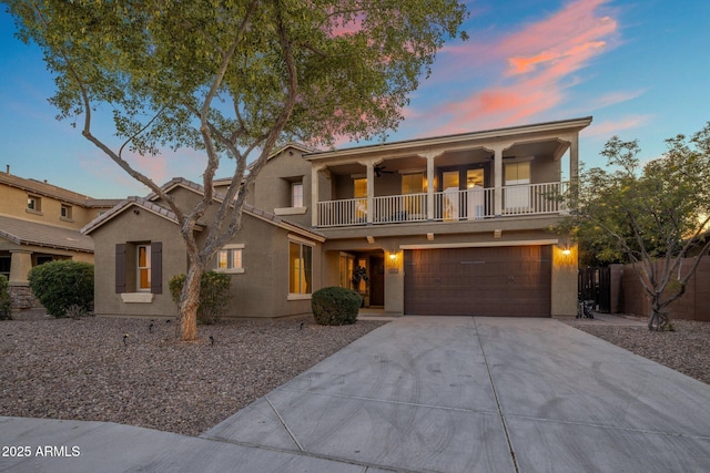7616 S Sorrell Ln, Gilbert, AZ 85298 - view of property featuring a balcony, a garage, stucco siding, and concrete driveway