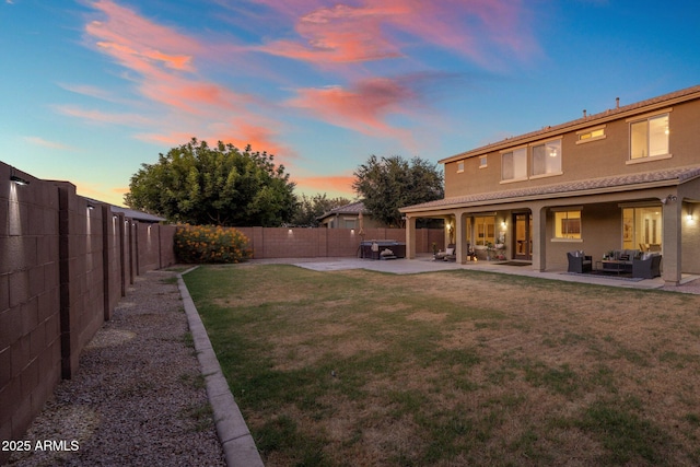7616 S Sorrell Ln, Gilbert, AZ 85298 - yard at dusk with an outdoor hangout area, a fenced backyard, and a patio area