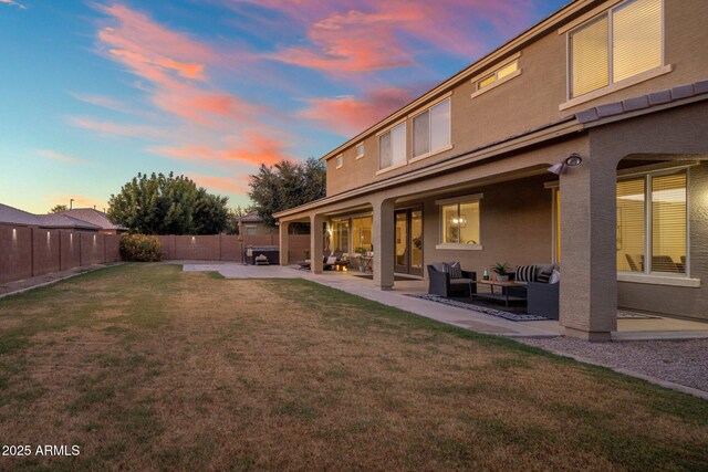 7616 S Sorrell Ln, Gilbert, AZ 85298 - yard at dusk with outdoor lounge area, a patio, and a fenced backyard