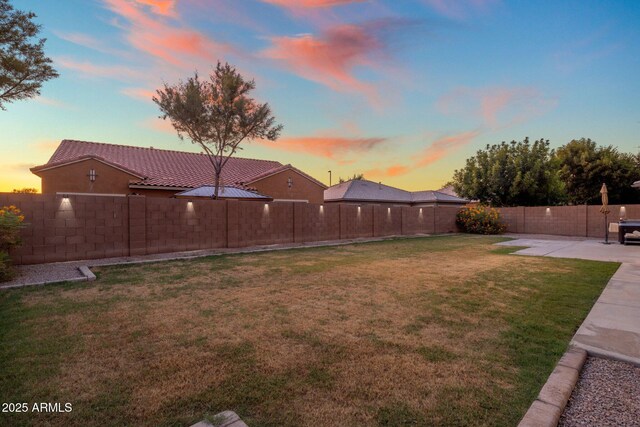 7616 S Sorrell Ln, Gilbert, AZ 85298 - yard at dusk with a patio area and a fenced backyard