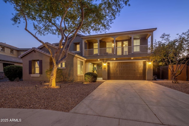7616 S Sorrell Ln, Gilbert, AZ 85298 - view of front of home featuring a balcony, driveway, an attached garage, stucco siding, and a ceiling fan