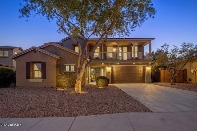 7616 S Sorrell Ln, Gilbert, AZ 85298 - view of front of house with a balcony, driveway, an attached garage, and stucco siding