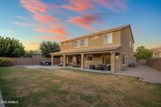 7616 S Sorrell Ln, Gilbert, AZ 85298 - back of house at dusk featuring an outdoor living space, a patio area, a fenced backyard, and stucco siding