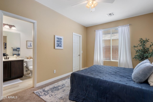 7616 S Sorrell Ln, Gilbert, AZ 85298 - bedroom with light carpet, connected bathroom, and a ceiling fan