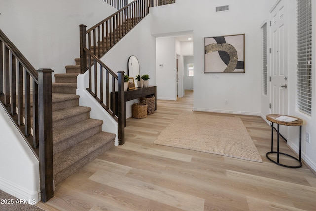 7616 S Sorrell Ln, Gilbert, AZ 85298 - foyer entrance with stairs, light wood-type flooring, and a towering ceiling