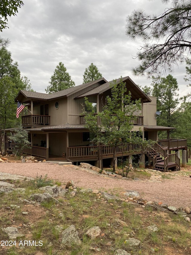 rear view of property with a balcony