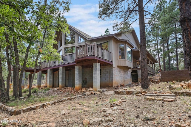 view of side of home featuring a wooden deck