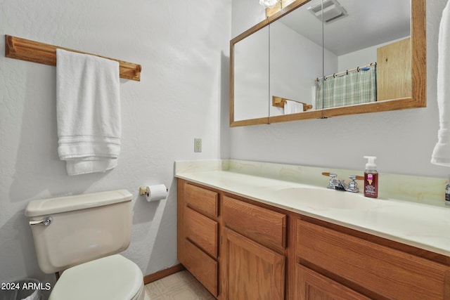 bathroom with vanity, toilet, and curtained shower