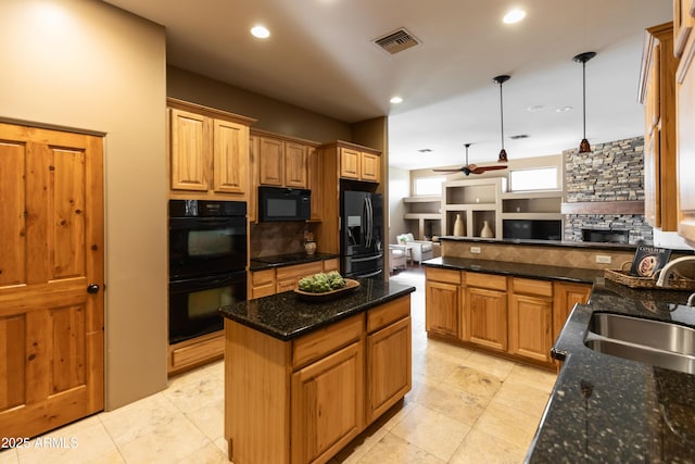 kitchen with black appliances, a kitchen island, sink, and tasteful backsplash