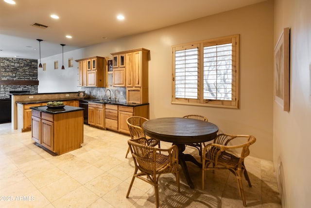 kitchen with backsplash, a center island, sink, black dishwasher, and hanging light fixtures