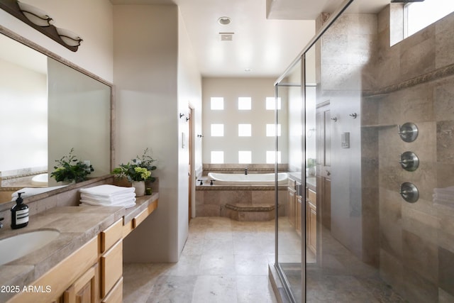 bathroom with vanity and separate shower and tub