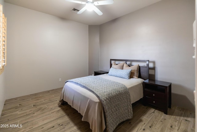 bedroom with light wood-type flooring and ceiling fan