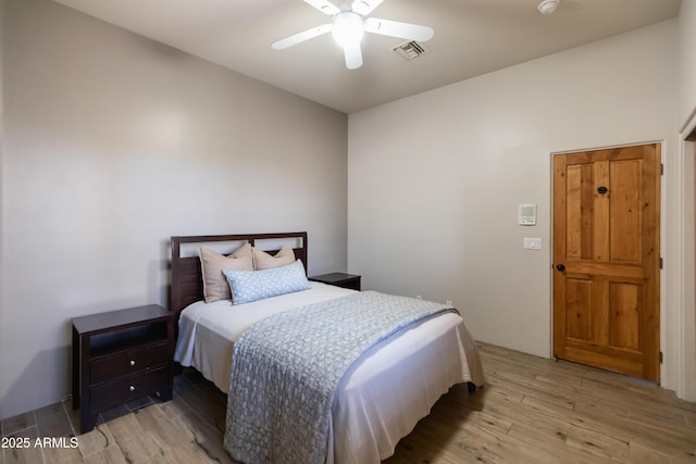 bedroom with light hardwood / wood-style floors and ceiling fan