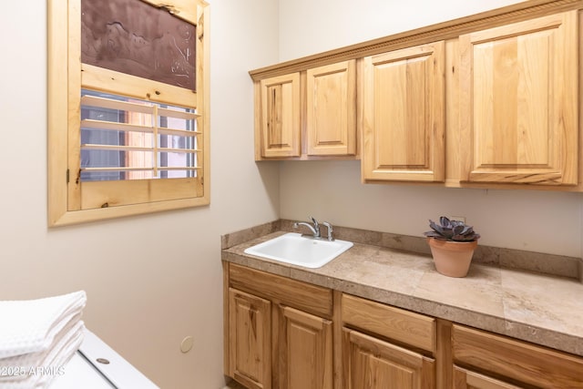 washroom with cabinets and sink