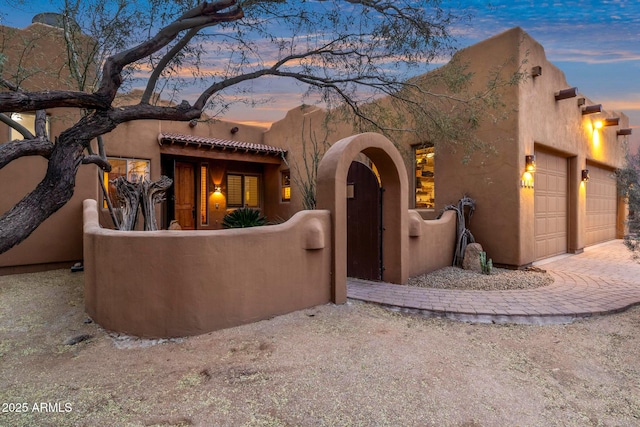 adobe home featuring a garage