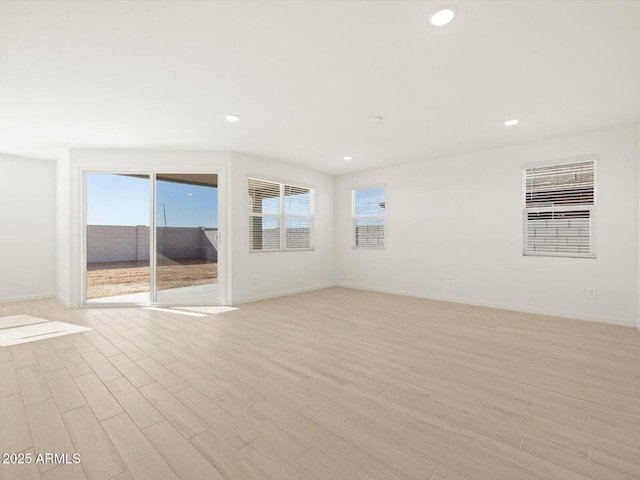 spare room with light hardwood / wood-style floors