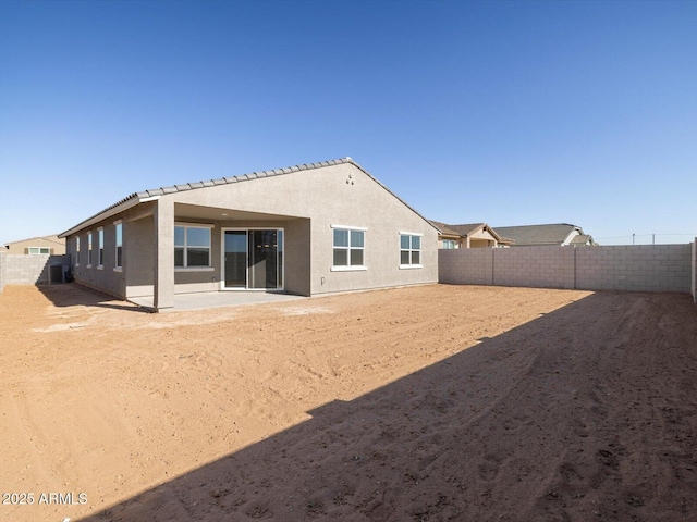 rear view of property featuring a patio area