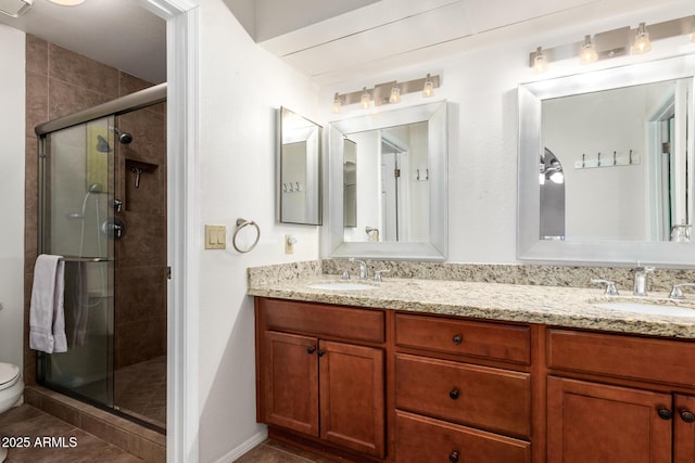 bathroom featuring tile patterned flooring, toilet, vanity, and walk in shower