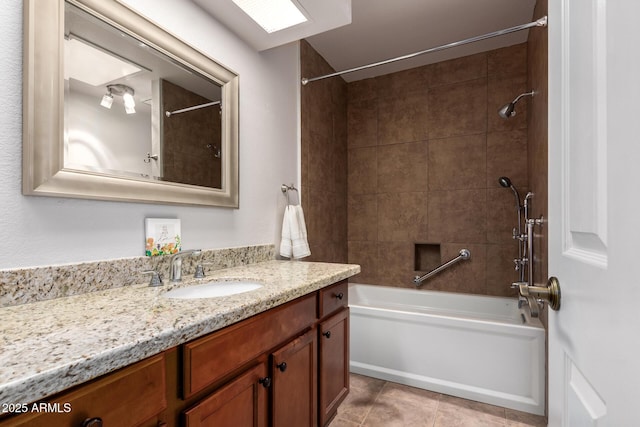 bathroom with tile patterned flooring, vanity, and tiled shower / bath