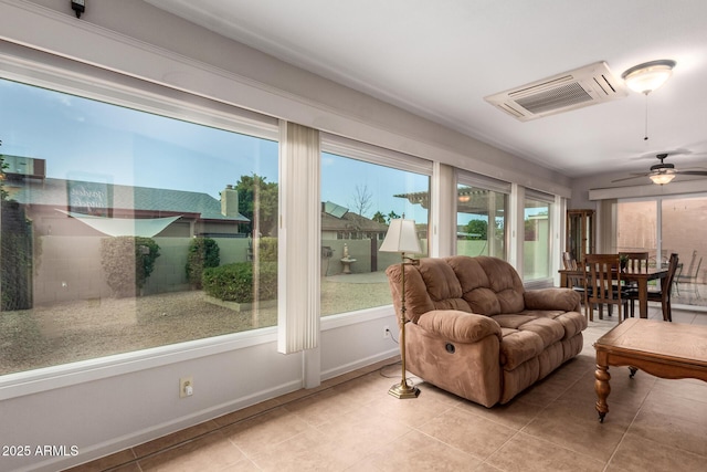 sunroom / solarium featuring ceiling fan