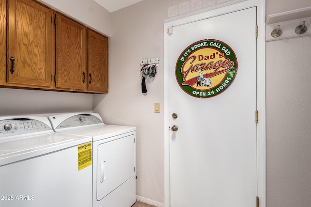 laundry room with cabinets and washer and dryer