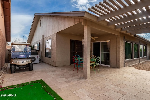 view of patio / terrace featuring ceiling fan and a pergola