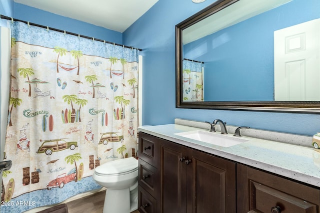 bathroom featuring vanity, hardwood / wood-style floors, toilet, and walk in shower