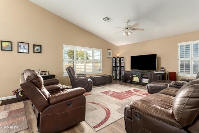 living room with lofted ceiling, ceiling fan, and light wood-type flooring