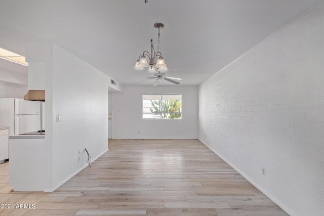 unfurnished dining area featuring visible vents, brick wall, ceiling fan with notable chandelier, and light wood finished floors