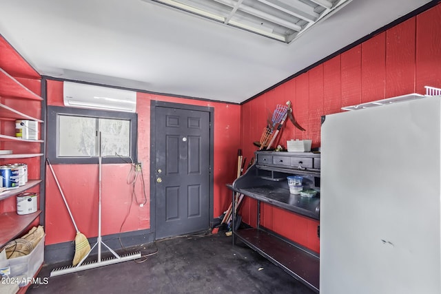 miscellaneous room featuring a wall unit AC and concrete floors