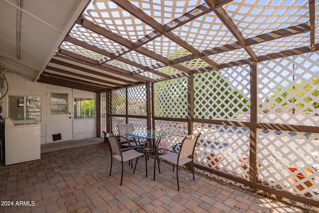 view of patio with a pergola, outdoor dining area, and washer / dryer