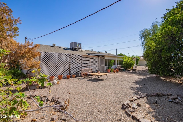 rear view of property with cooling unit and a patio area
