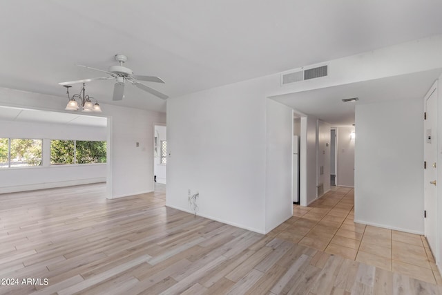 unfurnished room with baseboards, ceiling fan, visible vents, and light wood-style floors