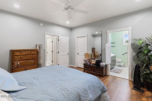 bedroom with recessed lighting, ceiling fan, wood finished floors, and ensuite bathroom