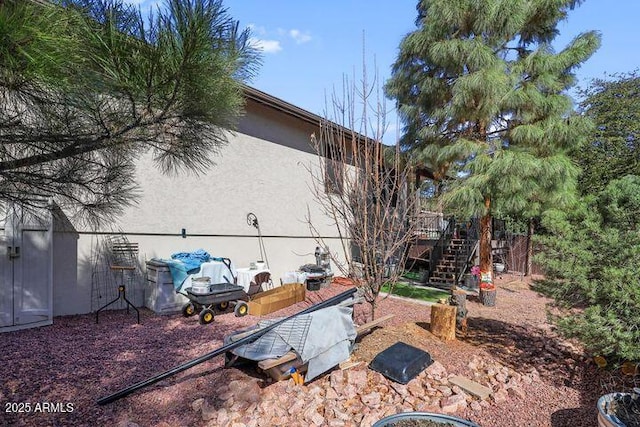 view of yard featuring stairway and a wooden deck