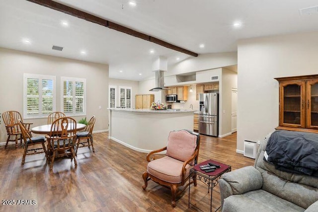 interior space with vaulted ceiling with beams, baseboards, and dark wood-type flooring