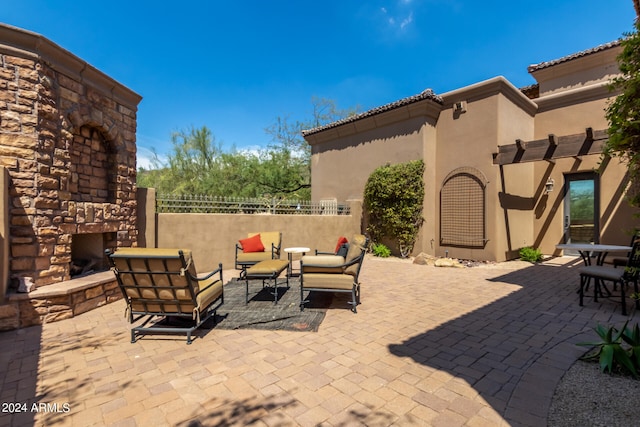 view of patio / terrace featuring an outdoor living space with a fireplace