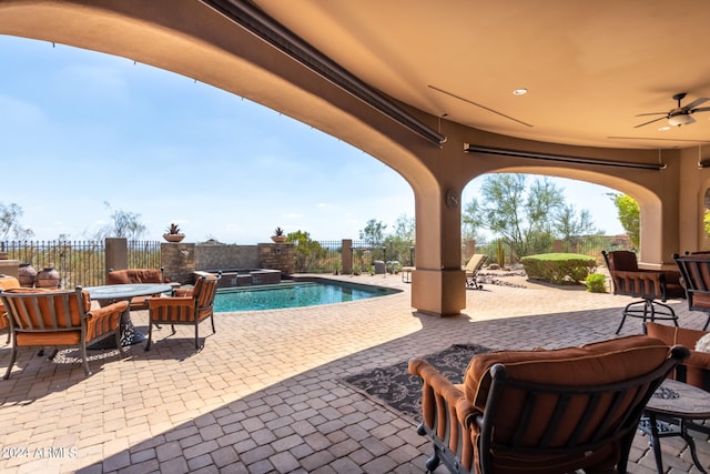 view of patio with ceiling fan and a fenced in pool