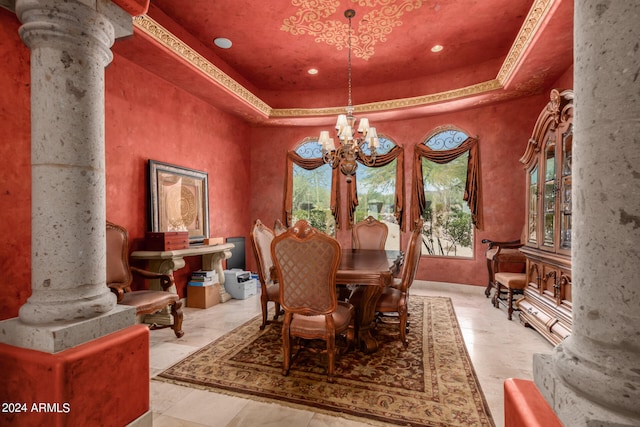 dining room with a raised ceiling, light tile patterned floors, ornate columns, and an inviting chandelier