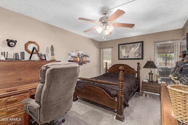 bedroom featuring a textured ceiling, a ceiling fan, and carpet floors