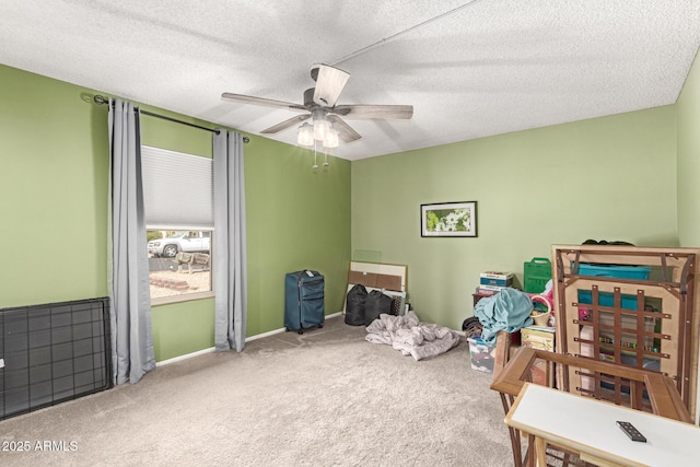 carpeted bedroom featuring baseboards, a textured ceiling, and a ceiling fan