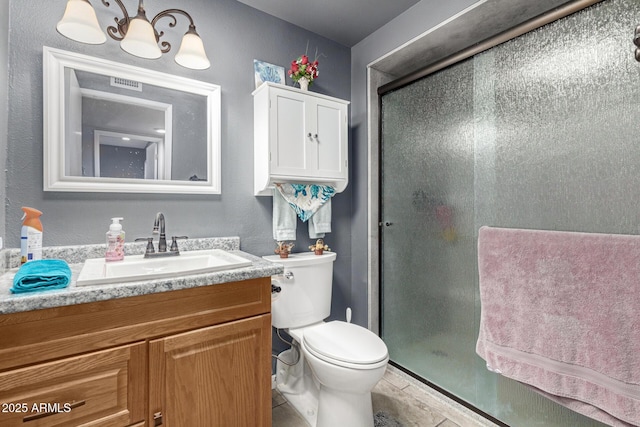 bathroom with visible vents, a stall shower, toilet, and vanity