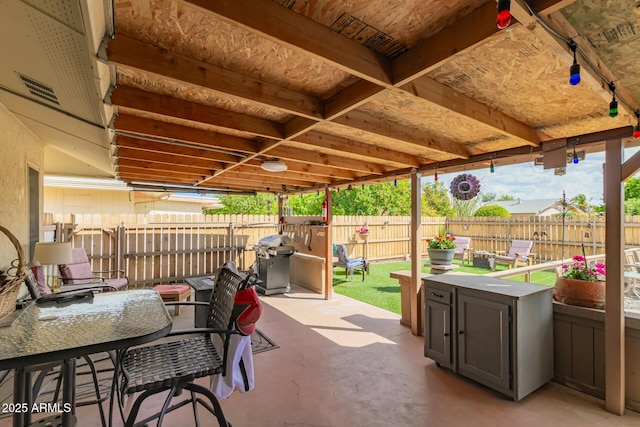 view of patio with grilling area, outdoor dining area, and fence private yard