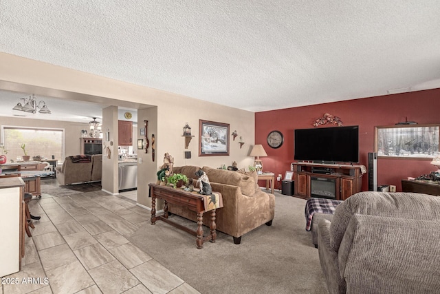 living area with visible vents, a textured ceiling, and ceiling fan