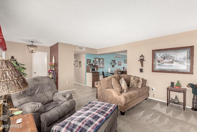 living area with baseboards, visible vents, carpet floors, and a textured ceiling