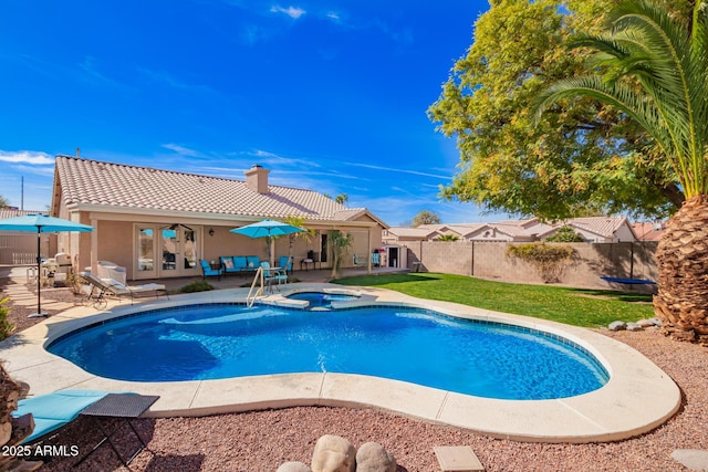 view of swimming pool featuring a pool with connected hot tub, french doors, a fenced backyard, and a patio